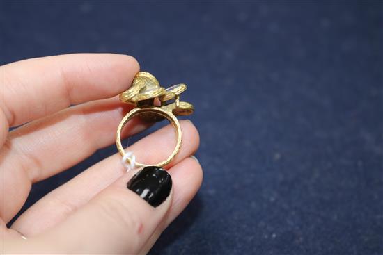 A 1970s textured 18ct gold and eight stone oval black opal set dress ring, size K/L.